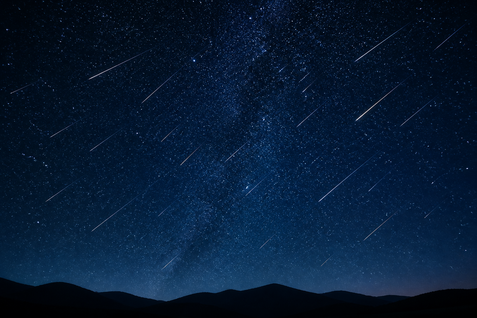 A moonless blue night sky over a dark ridgeline, crossed by several thin meteor streaks.